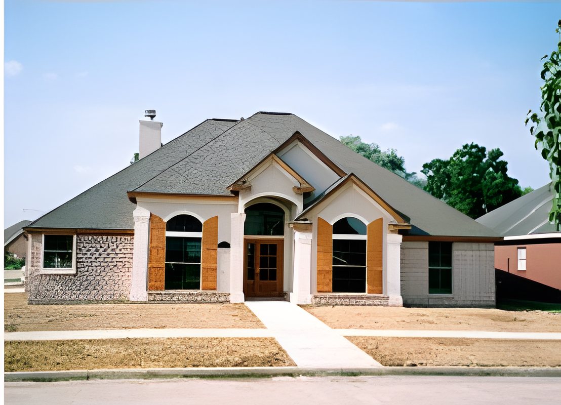 Brick custom home with arched windows and a hip roof